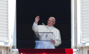 Pope Francis waves during his Sunday Angelus prayer in St. Peter's Square at the Vatican