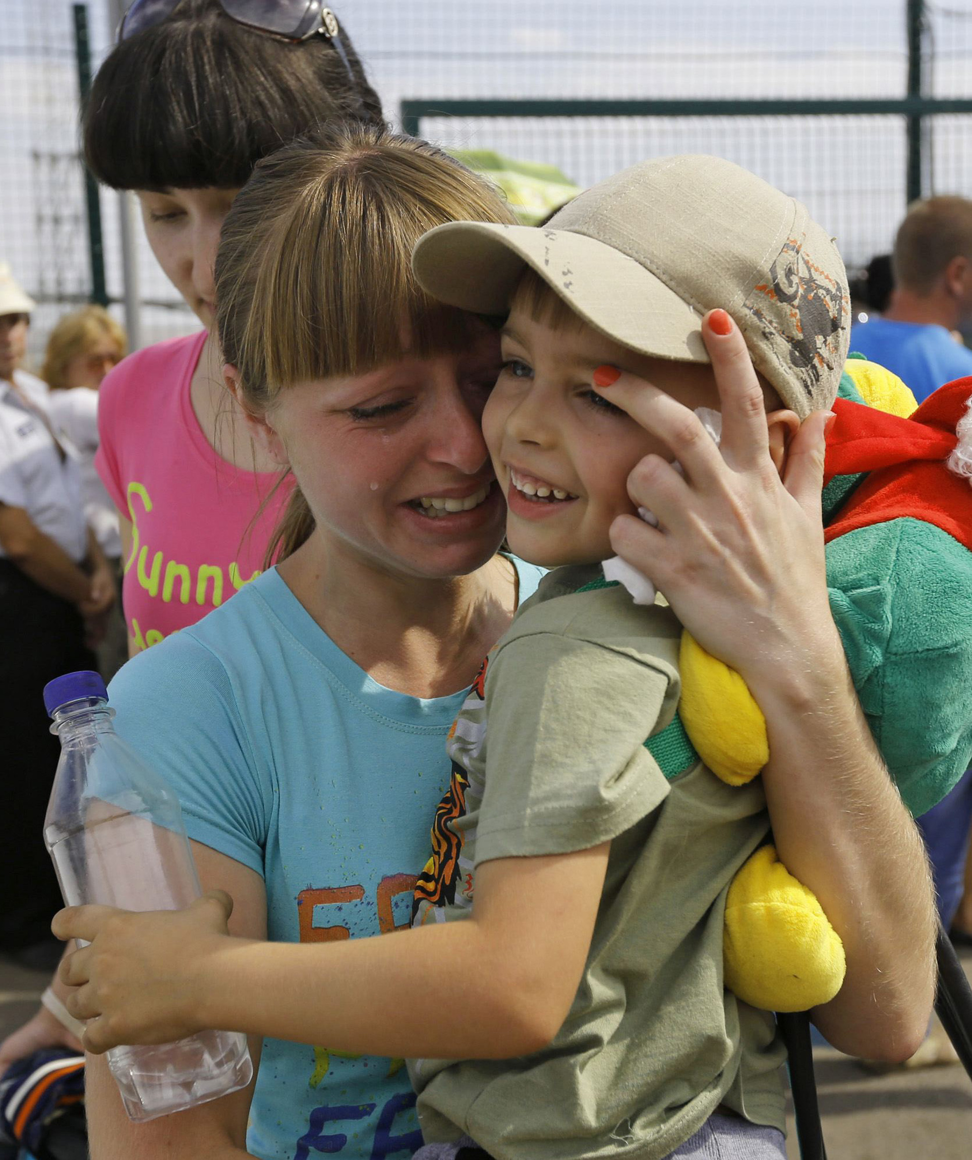 A Ukrainian woman weeps after being reunited with her son at the Russia-Ukraine border in Russia's Rostov region Aug. 22. Ukrainians mark Independence Day Aug. 24 amid ongoing tensions in the East. (CNS photo/Alexander Demianchuk, Reuters) See UKRAINE-INDEPENDENCE Aug. 22, 2014.