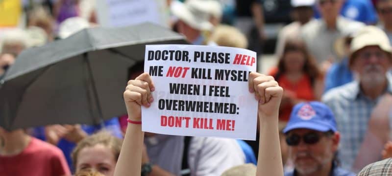 A woman holds up a sign during a rally against assisted suicide in 2016 on Parliament Hill in Ottawa, Ontario. In a Toronto speech, Cardinal Gerhard Muller, prefect of the Congregation for the Doctrine of the Faith, has urged Canadians to work to reverse euthanasia rulings. (CNS photo/Art Babych) See CANADA-MULLER-EUTHANASIA May 17, 2017.