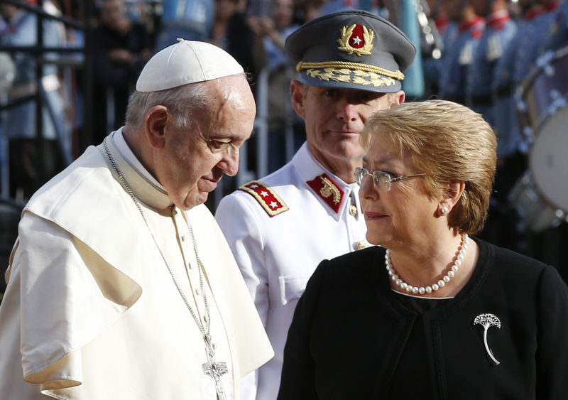 Pope Francis talks with Chilean President Michelle Bachelet as they arrive for a meeting with government authorities, members of civil society and the diplomatic corps at La Moneda presidential palace in  Santiago, Chile, Jan. 16. (CNS photo/Paul Haring) See POPE-CHILE-SOCIETY Jan. 16, 2018.