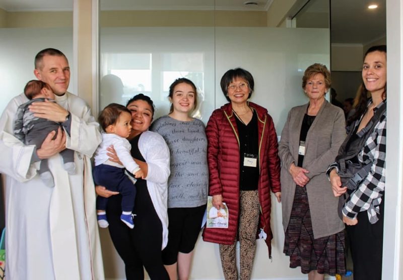 Bishop Michael Gielen with Dame Colleen Bayer (in brown cardigan), volunteer midwife Mary Seong (in red jacket) and mothers and babies at the opening of the St Gianna Home for Mothers and Babies. (Photo: Amie Kaufman)

