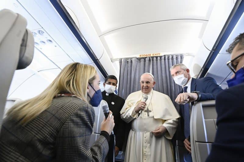 Pope Francis answers questions from journalists aboard his flight from Athens, Greece, to Rome Dec. 6, 2021. In comments to reporters on the plane the pope said that the idea of not talking about Christmas is "an anachronism" reminiscent of the dictatorships of days gone by, including the communists. (CNS photo/Vatican Media)