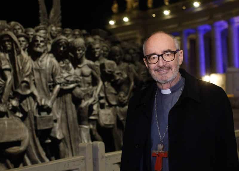 Canadian Cardinal Michael Czerny, undersecretary for migrants and refugees at the Vatican Dicastery for Promoting Integral Human Development, poses for a photo at the "Angels Unawares" statue in St. Peter's Square at the Vatican Dec. 15, 2020. In a virtual presentation Sept. 13, 2021, the cardinal urged Mexican bishops to prioritize migrant ministries, even in dioceses without significant migrant flows. (CNS photo/Paul Haring)