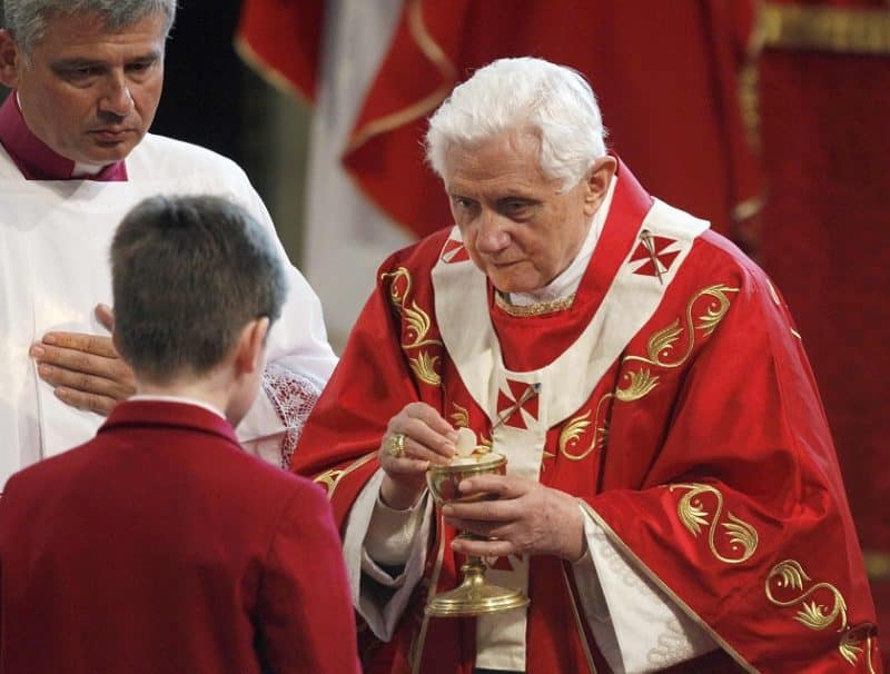Pope Benedict XVI gives Communion to a young man during Mass at Westminster Cathedral in London in this Sept. 18, 2010, file photo. During the service the pope expressed his "deep sorrow" to the victims of clerical sexual abuse, saying these crimes have caused immense suffering and feelings of "shame and humiliation" throughout the church. (CNS photo/Reuters pool)