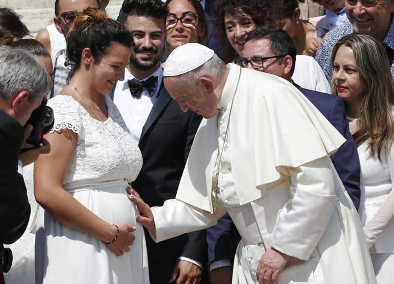 Pope Francis blesses the womb of a pregnant woman during his general audience in St. Peter's Square at the Vatican June 5, 2019. In a message sent May 12, 2022, to participants of a conference in Rome, Pope Francis said declining birth rates in Italy and Western countries are "impoverishing everyone's future." (CNS photo/Paul Haring)