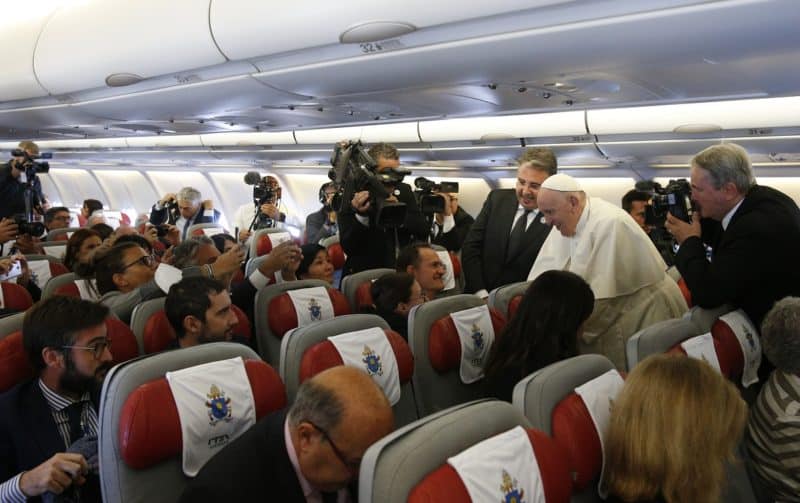 Pope Francis greets journalists aboard his flight from Rome to Nur-Sultan, Kazakhstan, Sept. 13, 2022. Pope Francis' theme for the 2023 World Communication Day will be "Speak with the heart: 'Veritatem facientes in caritate' ('Speaking truth in love')," the Vatican announced Sept. 29.  (CNS photo/Paul Haring)